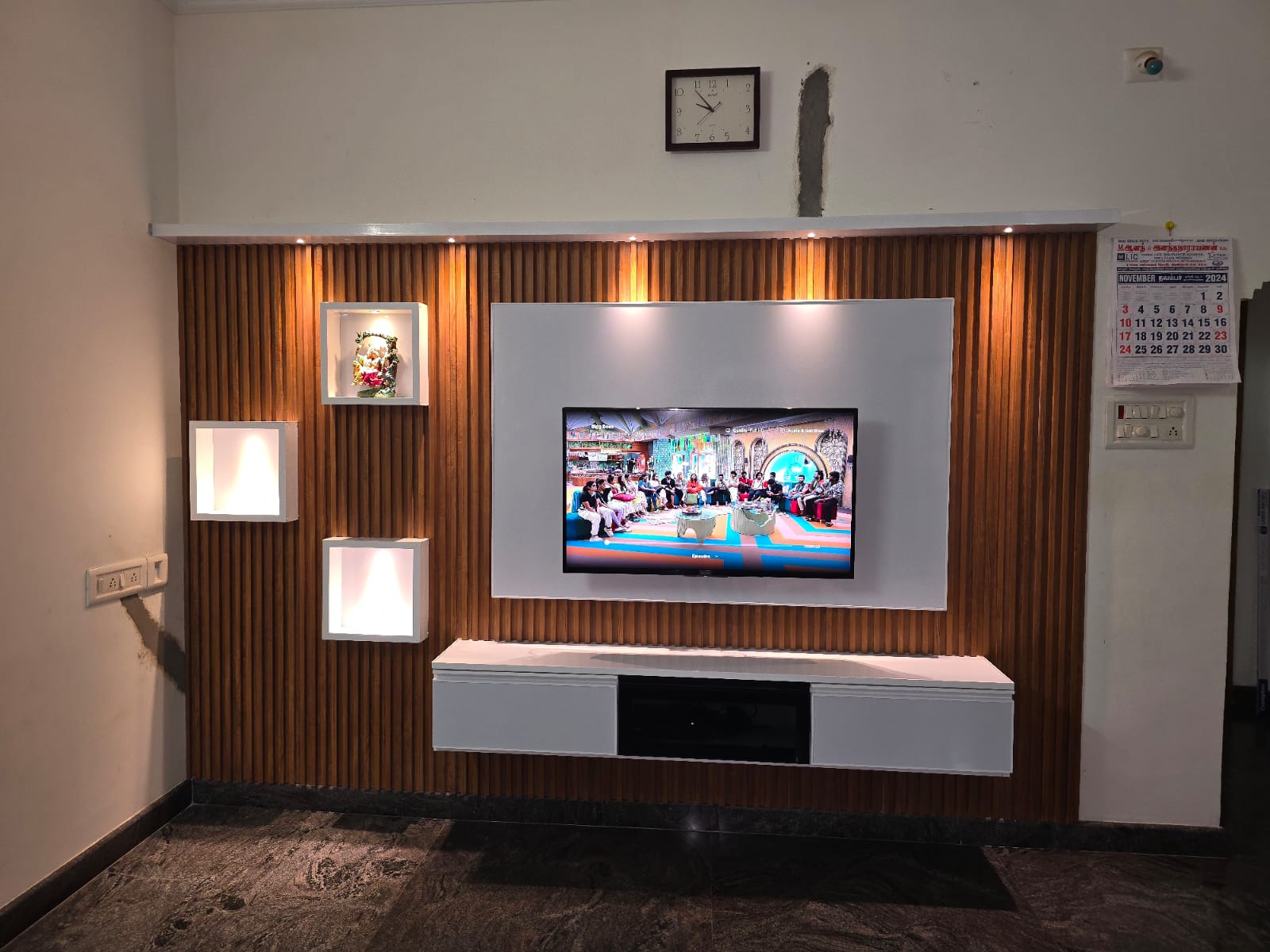 Television wall with warm wood slat detailing
